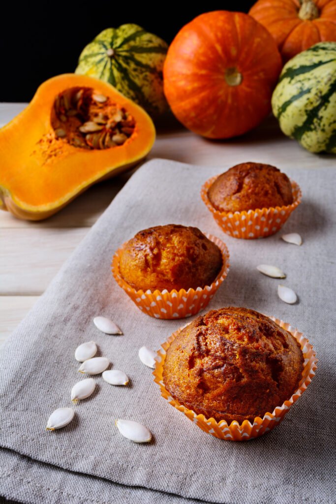 pumpkin muffins orange wrappers with squash seeds