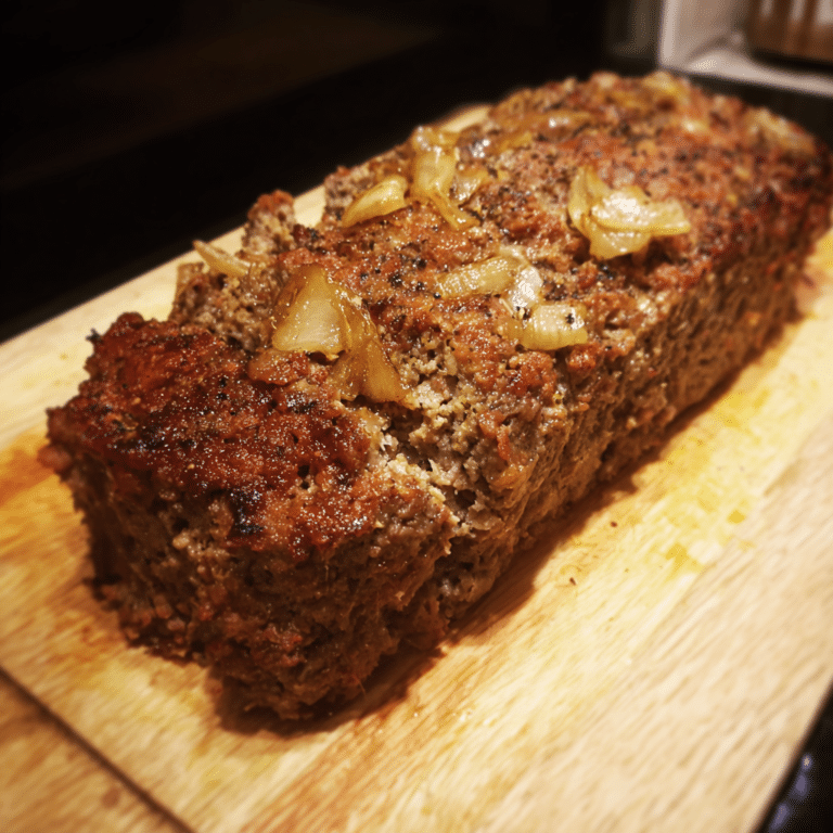 Classic Meatloaf with Onion and Garlic mixes savory beef with aromatic spices into a hearty and flavorful dish.