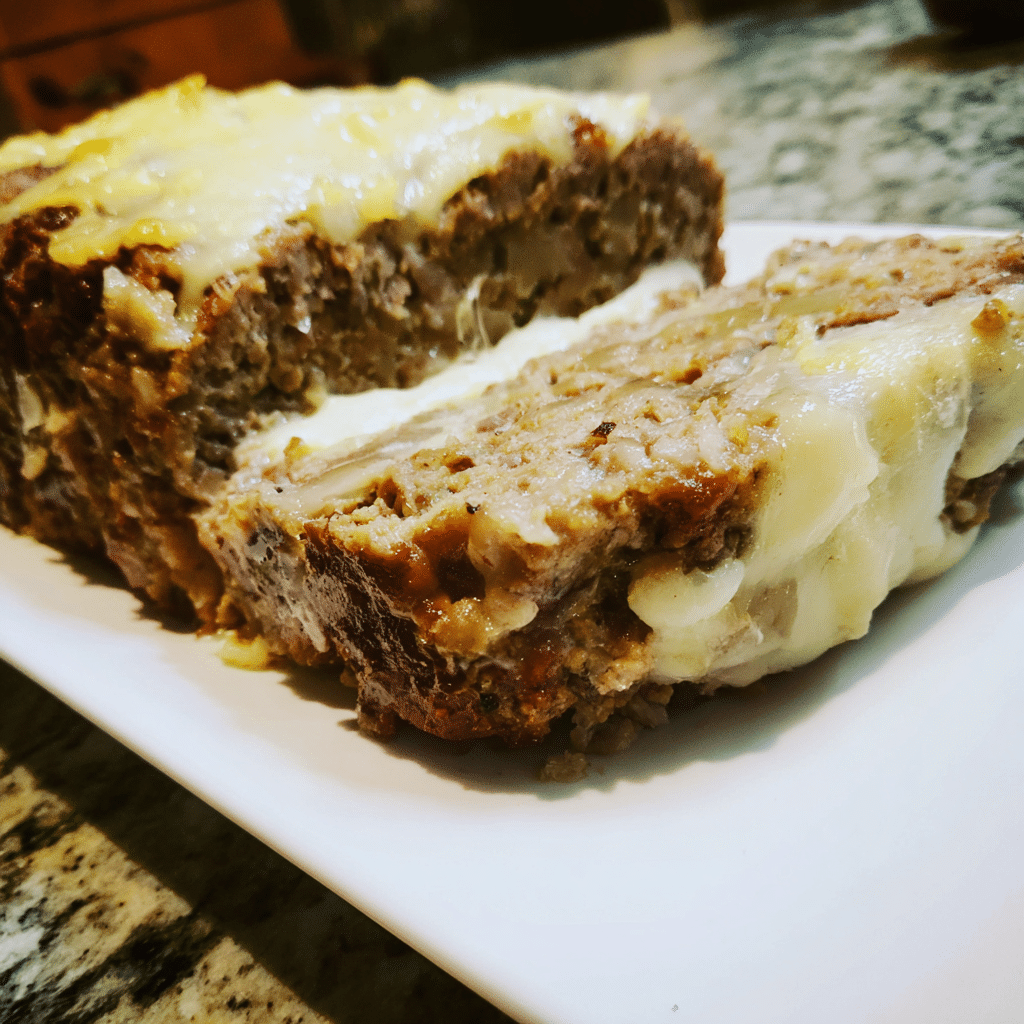 French Onion Meatloaf with Swiss Cheese Topping layers beef, onions, and cheese for a savory, hearty variation.