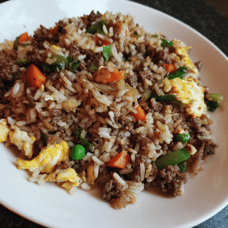 Ground Beef Stir-Fried Rice blends rice, beef, vegetables, and savory sauce into a quick, flavorful one-pan meal.