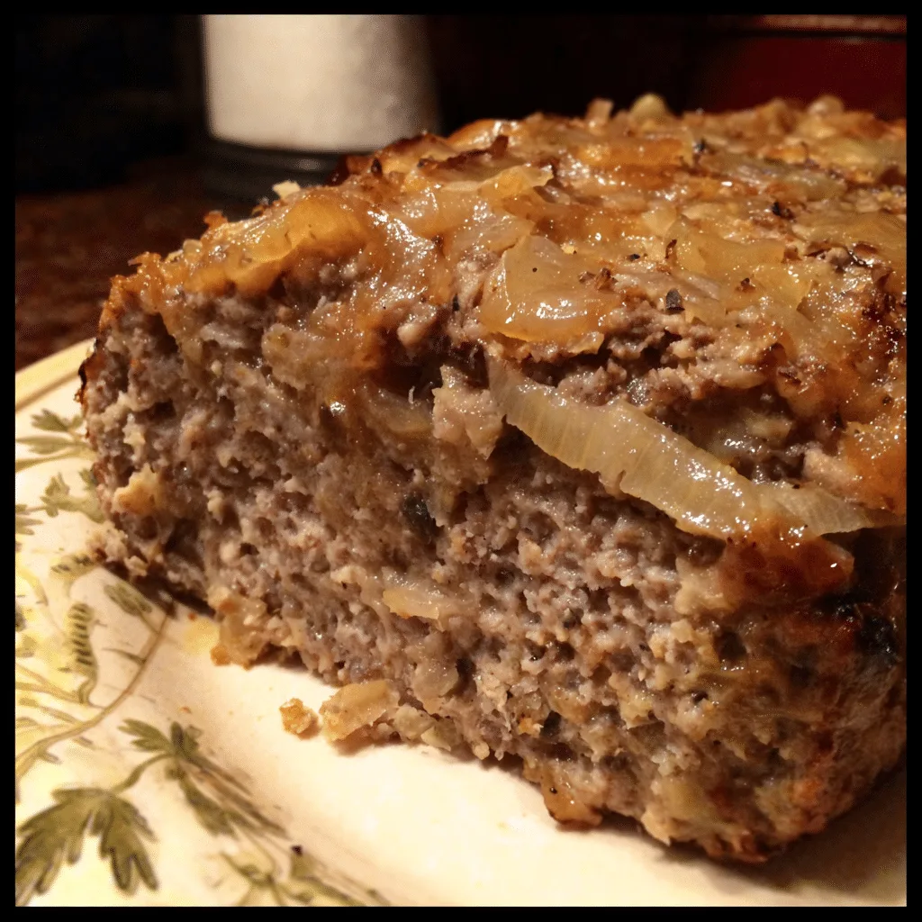 Slow Cooker French Onion Meatloaf simmers beef, onions, and cheese into a tender, flavorful dish.